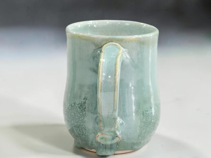 Handmade ceramic mug with natural glaze variation and kiln movement