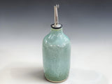 Artisan ceramic oil cruet in soft green glaze for modern farmhouse kitchen