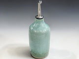 Handcrafted stoneware olive oil bottle with reactive spearmint glaze detail