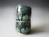 Handmade pottery tea cups in a green and glossy blue black glaze
