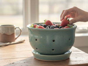 Handmade ceramic berry bowl with saucer in green-blue glaze