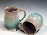 Handmade ceramic mug shown upright and on its side, green glazed stoneware pottery mug
