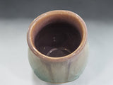 Handmade pottery salt pig with wooden spoon, crafted in Melbourne and finished with layered brown and green glazes for a unique artisan appearance.