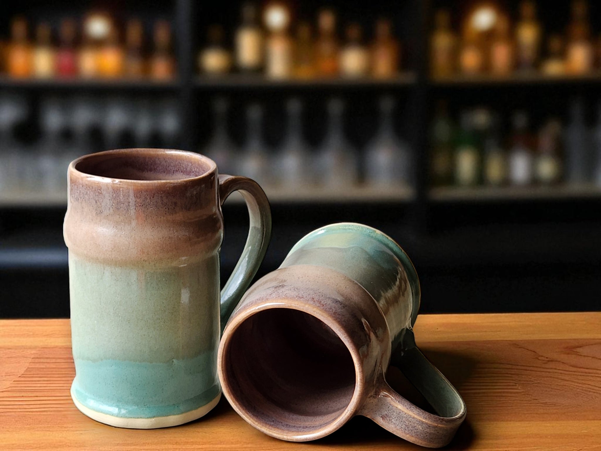 Handmade ceramic beer steins with green and brown glaze