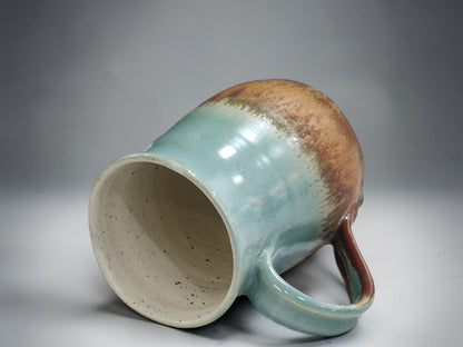 Tall handmade ceramic mug with elegant curved shape