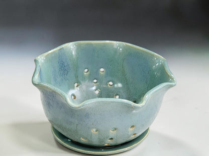 Green pottery berry bowl with scalloped rim and drainage holes