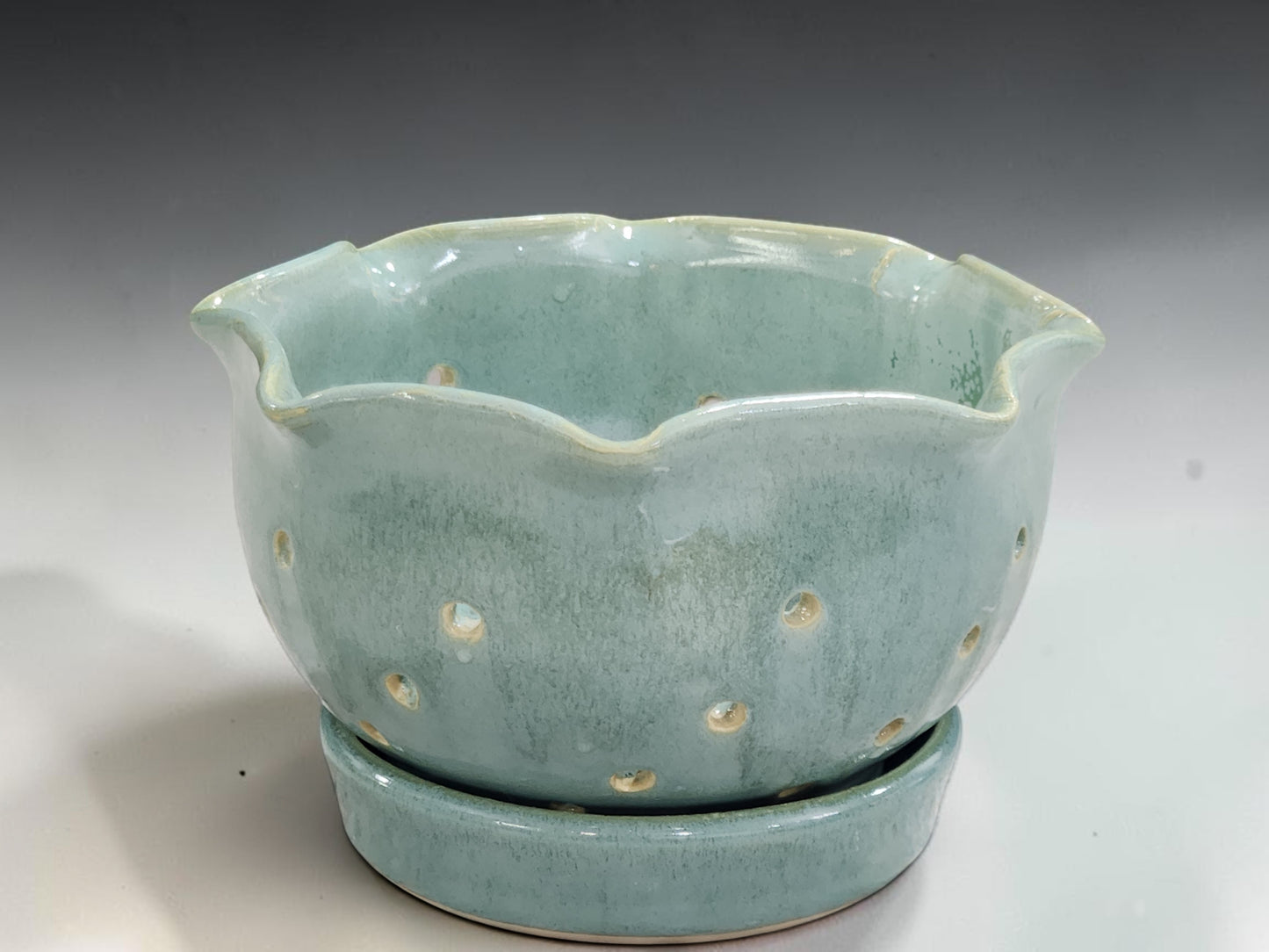 Australian handmade pottery berry colander bowl with scalloped rim and matching drip plate