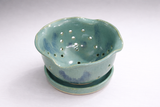 Stoneware colander bowl for berries in green and blue speckled glaze