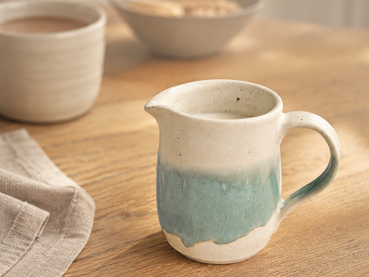 Handmade 300ml spearmint pottery jug in a warm breakfast-table setting
