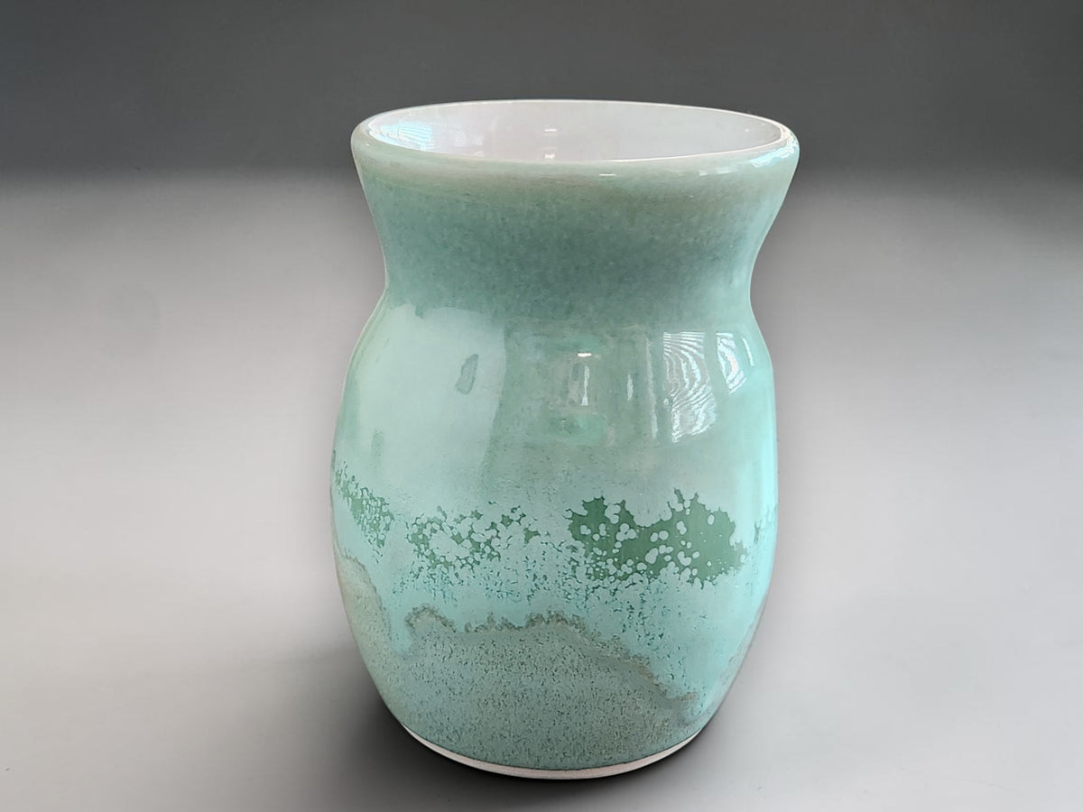 Small handmade pottery vase with curved silhouette