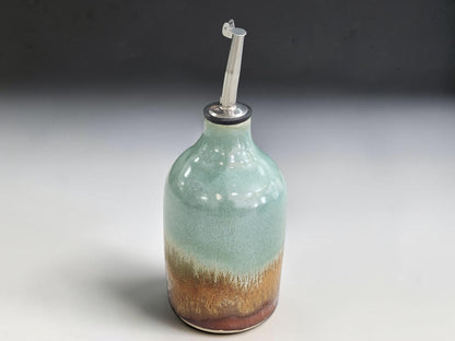Ceramic oil bottle measuring 14.5cm tall and 8cm across