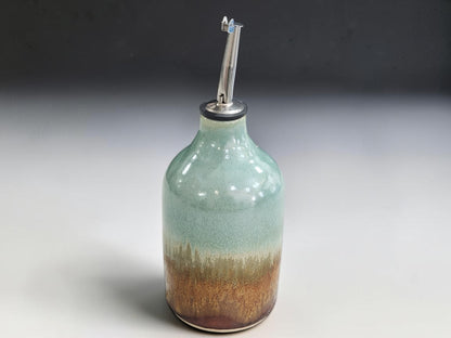Handmade olive oil dispenser with green, ochre and red-brown glazes
