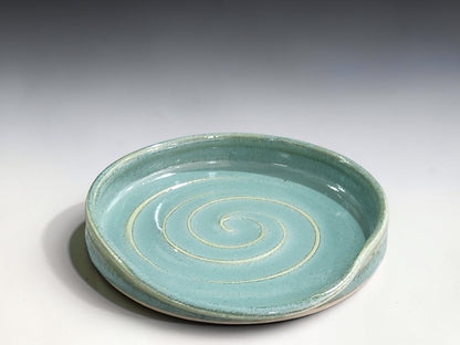 Wheel-thrown ceramic spoon rest in spearmint green with carved spiral detail, handcrafted in Melbourne.