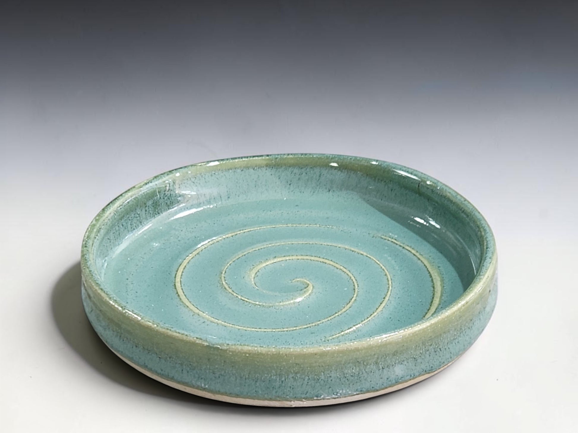 Modern ceramic spoon rest with soft spearmint green glaze, handcrafted by Buxton Pottery in Australia.
