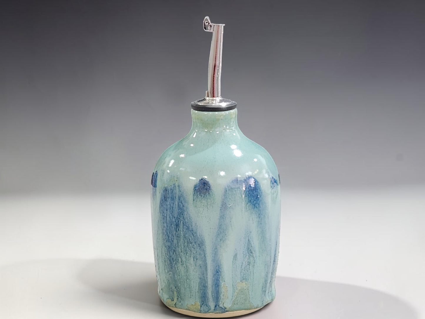 Handmade stoneware oil bottle with stainless steel pourer, crafted by Buxton Pottery in Melbourne Australia