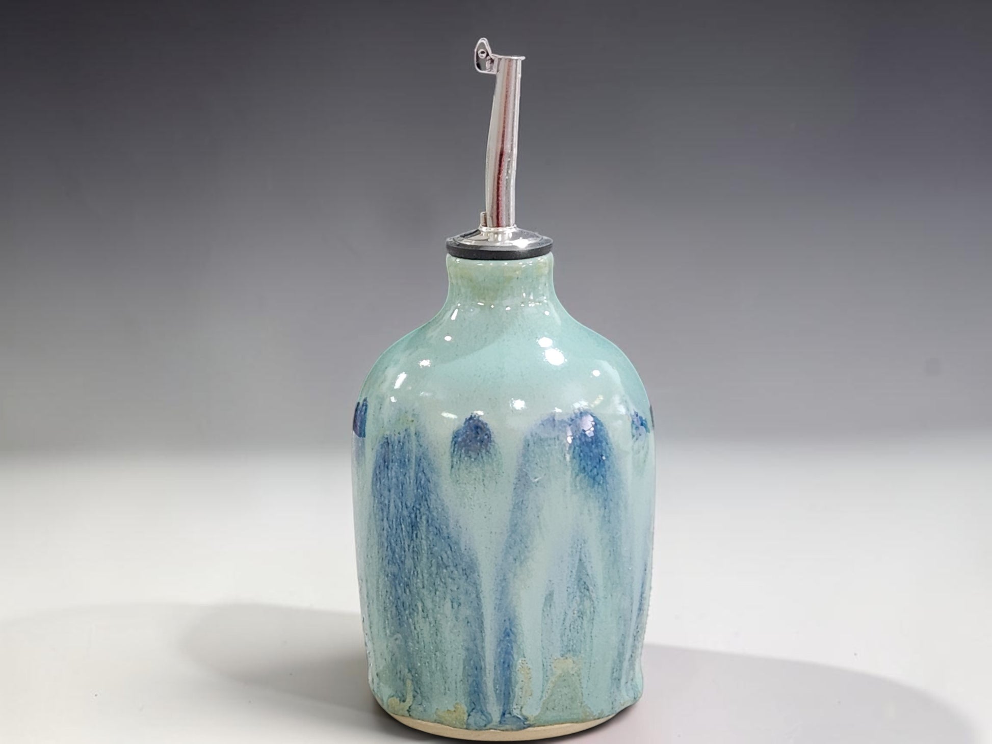 Handmade stoneware oil bottle with stainless steel pourer, crafted by Buxton Pottery in Melbourne Australia