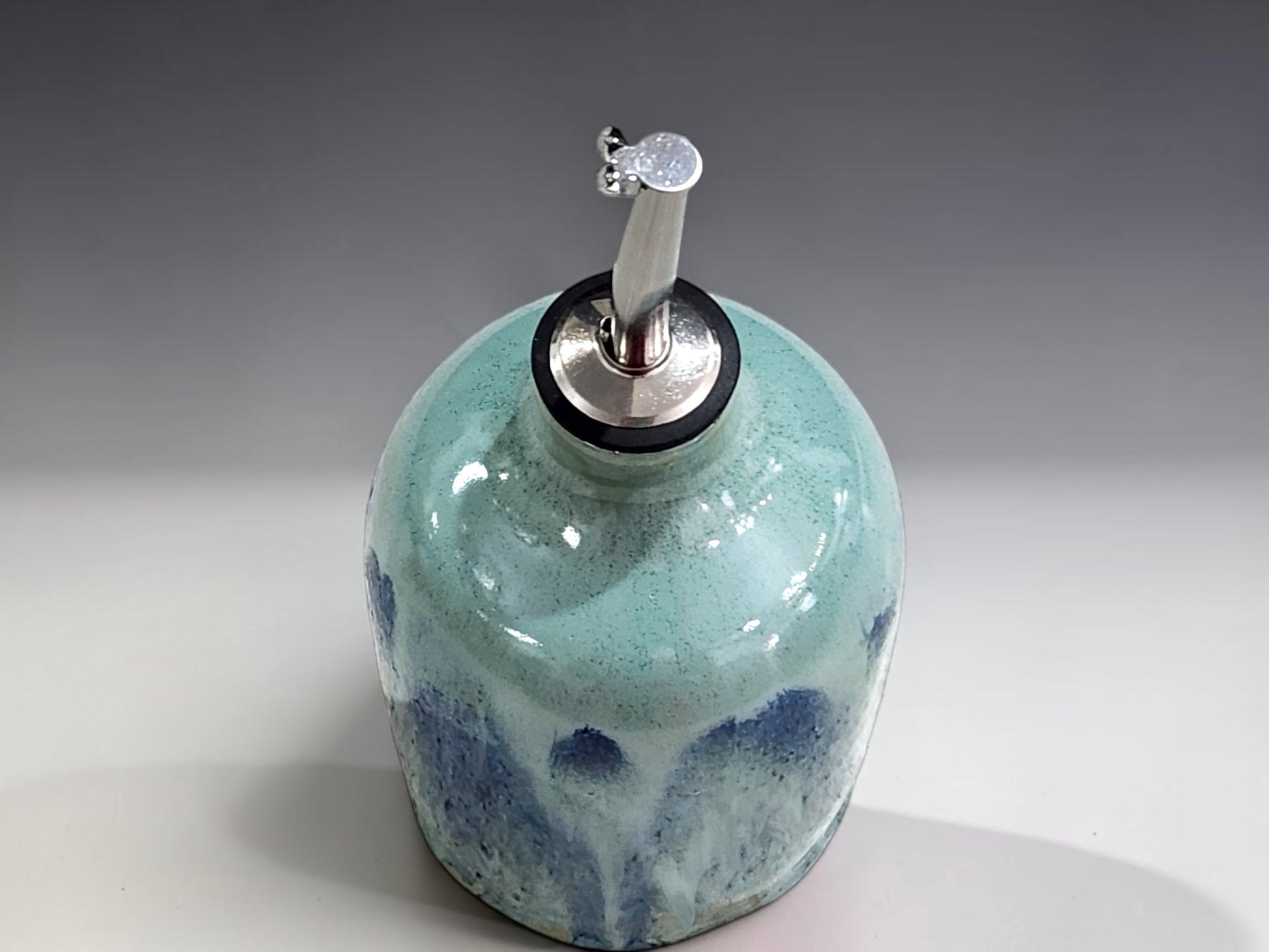 Handmade pottery oil dispenser with blue green glaze, ideal for olive oil vinegar or salad dressing