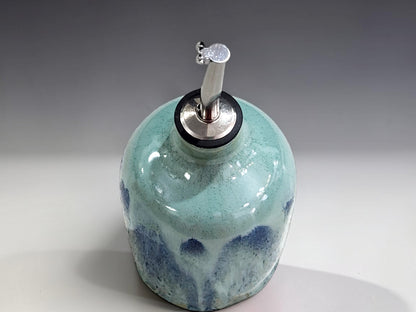 Handmade pottery oil dispenser with blue green glaze, ideal for olive oil vinegar or salad dressing