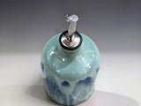 Handmade pottery oil dispenser with blue green glaze, ideal for olive oil vinegar or salad dressing
