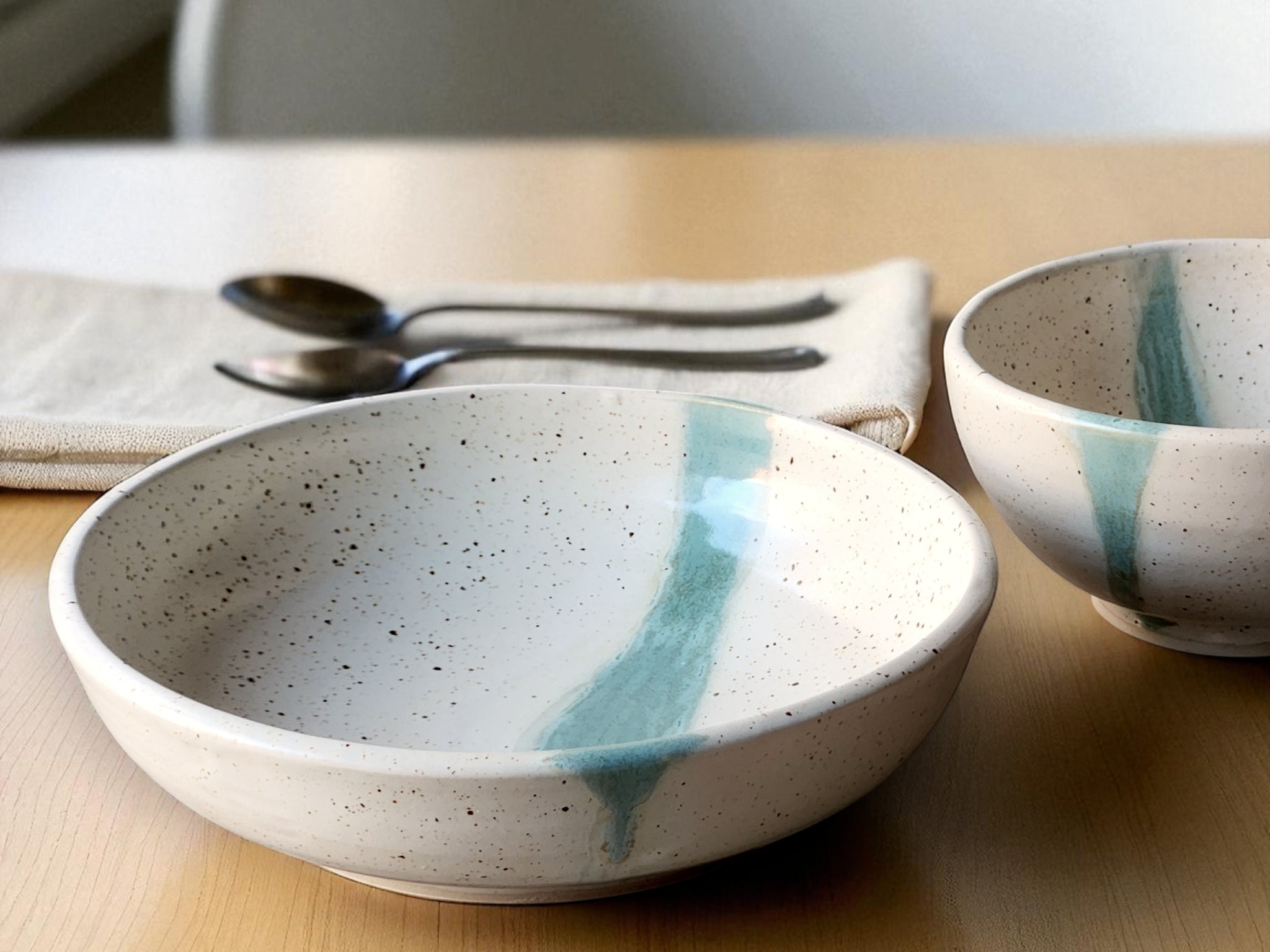 Handmade pottery pasta bowl speckled cream with green slash
