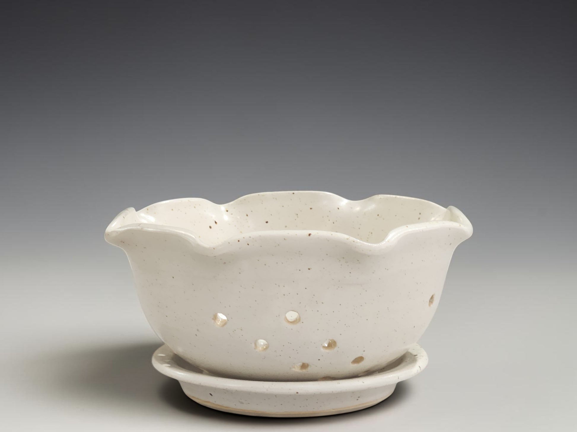 Handmade ceramic berry bowl with matching saucer in speckled cream glaze, crafted by Buxton Pottery in Melbourne Australia