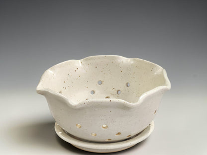 Handmade pottery berry bowl with drainage holes and saucer for rinsing and serving fresh strawberries