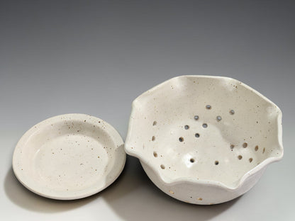Handmade pottery fruit bowl with drainage holes and matching drip tray for everyday kitchen use