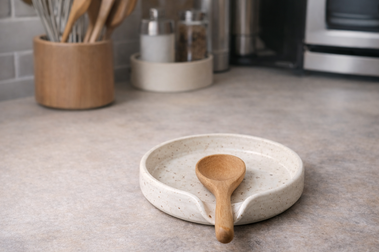 handmade pottery speckled cream spoon rest with a wooden spoon , 