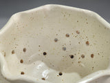 close up of Functional handmade colander bowl for rinsing and serving berries