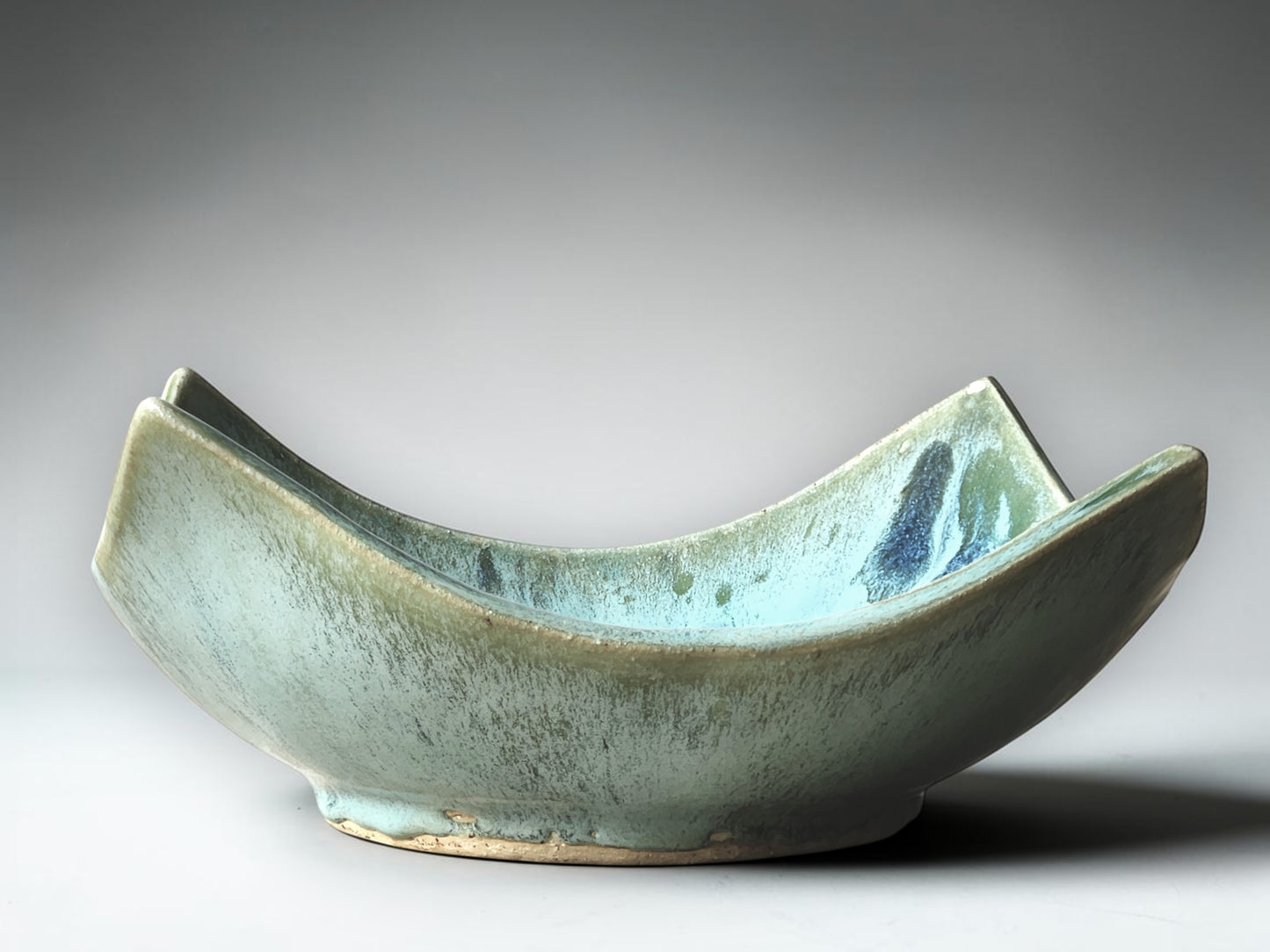 Unique wavy-edge ceramic bowl with glossy turquoise glaze and organic form