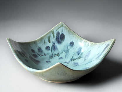 Coastal-inspired ceramic serving dish with curved silhouette and handcrafted finish