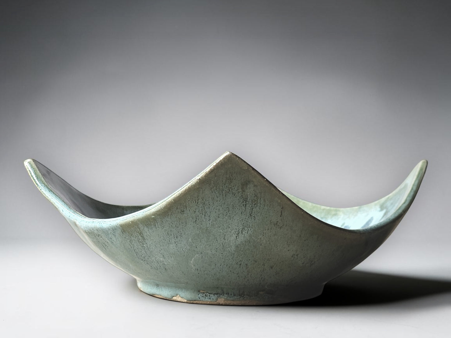 Contemporary artisan pottery bowl in soft aqua glaze with organic square shape