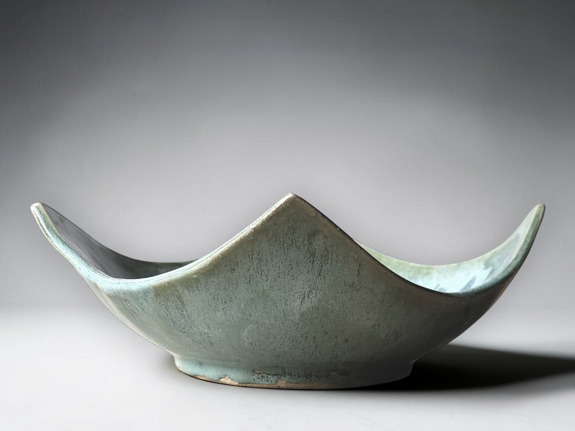 Contemporary artisan pottery bowl in soft aqua glaze with organic square shape