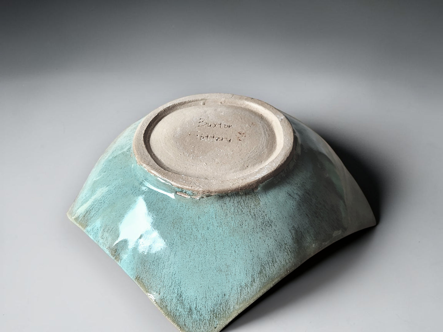 The underside of a Modern handcrafted pottery centerpiece bowl for dining or coffee table styling