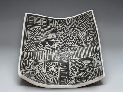 Handcrafted black and white carved drape bowl with geometric tribal-inspired patterns