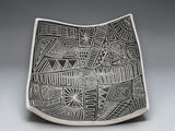 Handcrafted black and white carved drape bowl with geometric tribal-inspired patterns