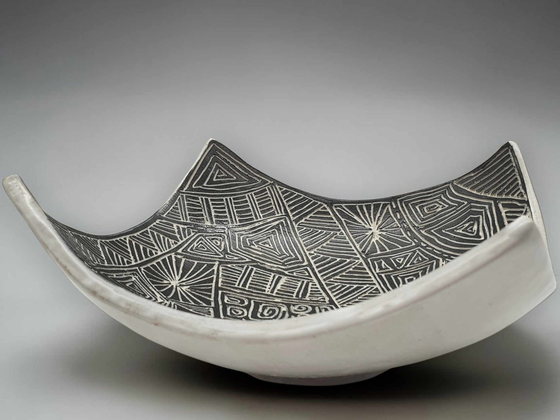Contemporary ceramic centerpiece bowl with monochrome etched interior detailing