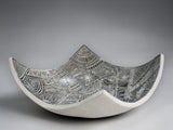 Artisan pottery bowl featuring hand-carved black and white abstract linework