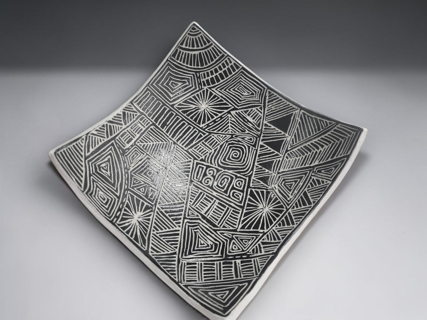 Modern ceramic serving bowl with textured black pattern and white outer finish