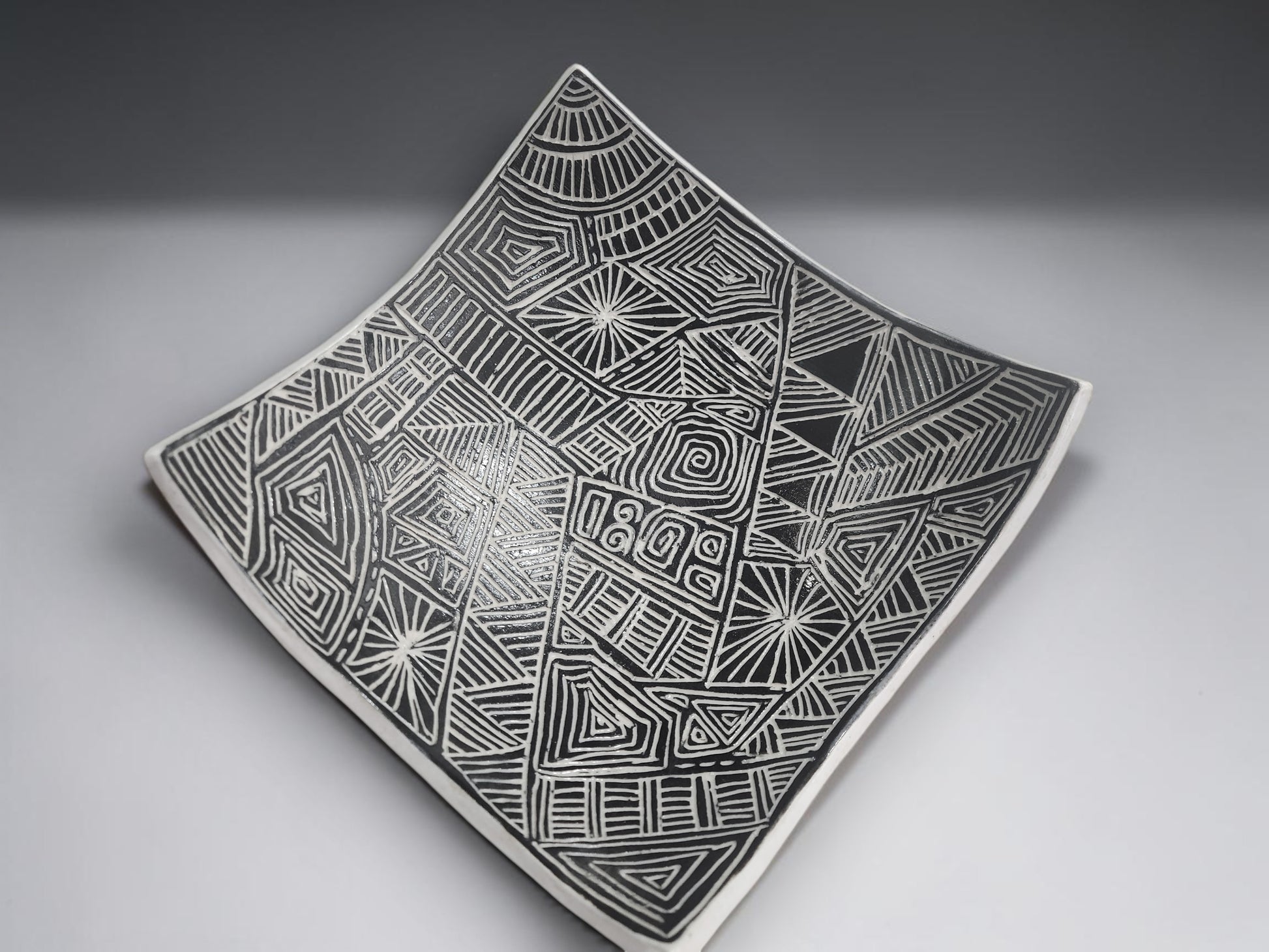 Modern ceramic serving bowl with textured black pattern and white outer finish