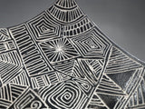 Close up of a Decorative sculptural bowl with curved drape edges and intricate geometric design