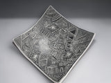 Modern ceramic serving bowl with textured black pattern and white outer finish