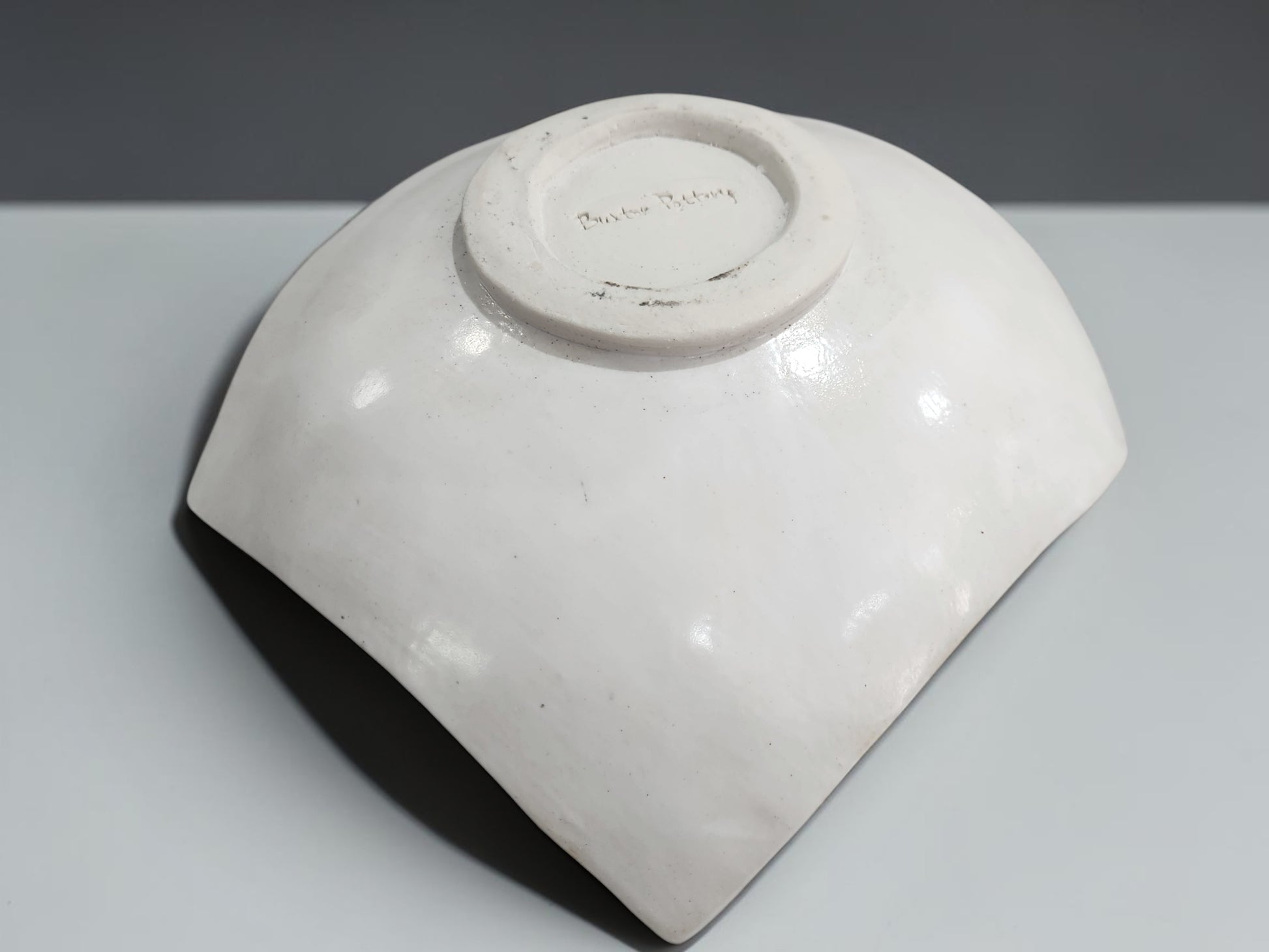 Under side of a Unique drape-style ceramic bowl with tribal-inspired etched pattern and organic shape