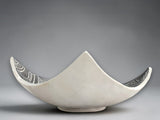 Handmade monochrome pottery bowl with elevated corners and engraved surface art