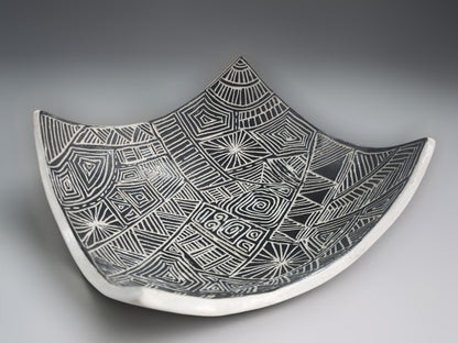 Stylish black and white ceramic fruit bowl with artisan carved decorative interior