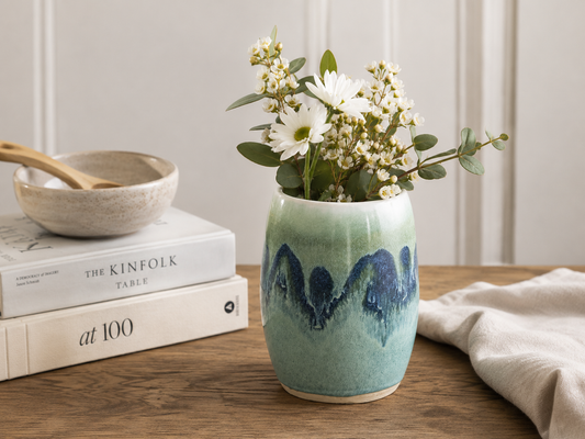 Handmade Australian ceramic vase with fresh white flowers in layered green and blue glazes displayed in a contemporary home setting by Buxton Pottery.