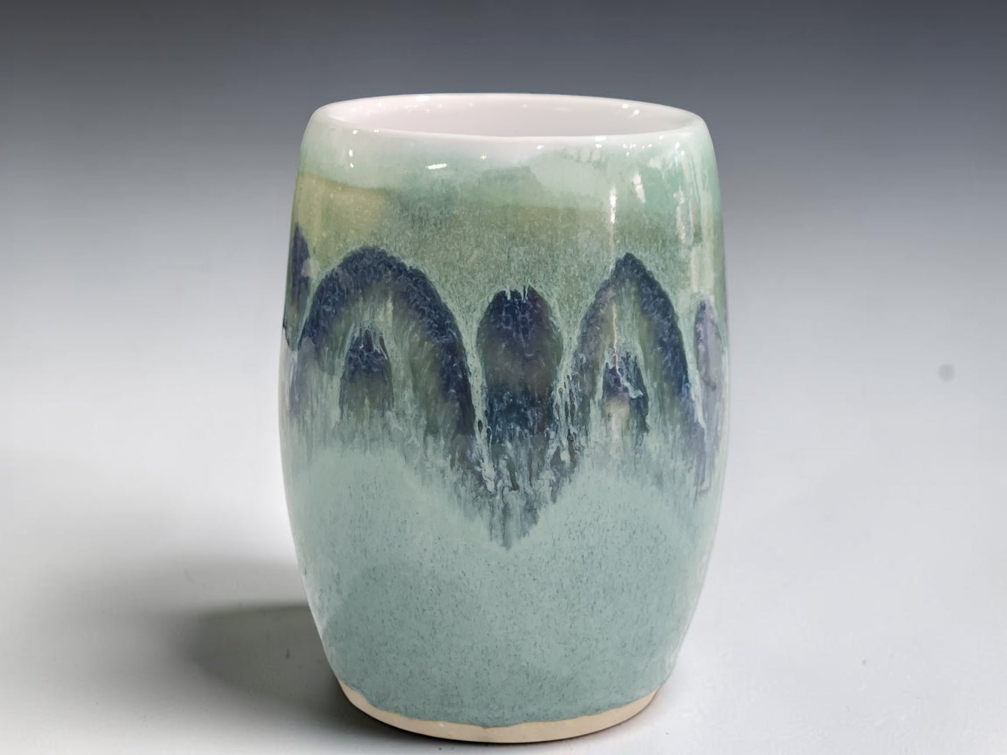 Handmade stoneware flower vase with layered sea mist green and deep blue glazes.
