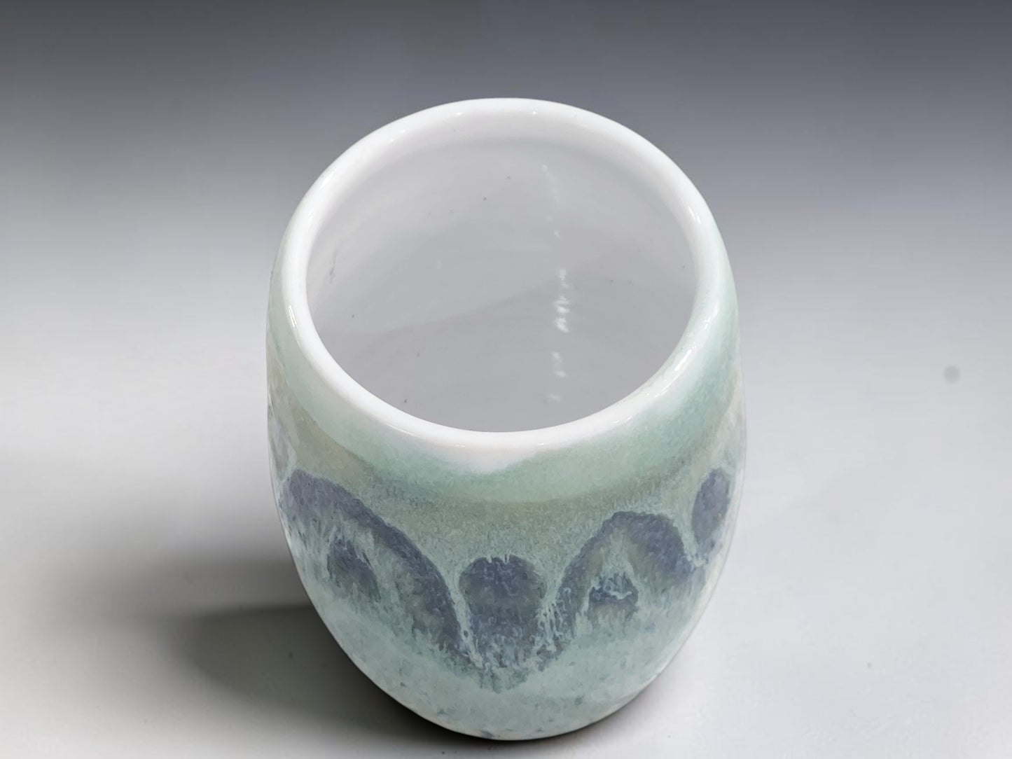 Top view of handmade stoneware vase with white glazed interior.