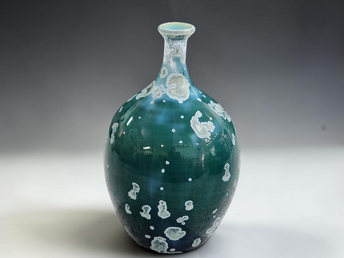 total body detail showing small scattered crystals near the base of the handmade vase.