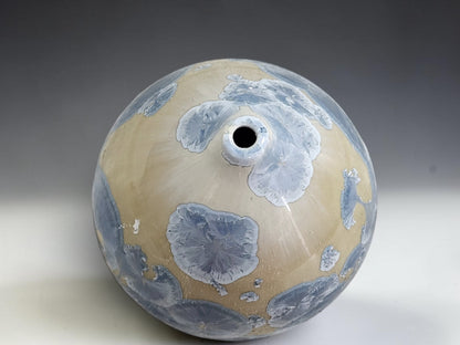 Upper view showing the opening and cream glaze of the small crystalline ceramic pot.